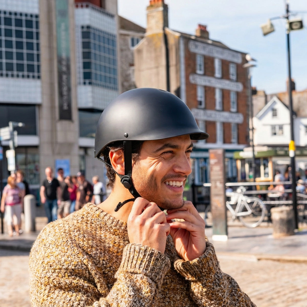 Man fastening the strap of a Sea Shepherd x Dashel Ocean Edition Black bike helmet